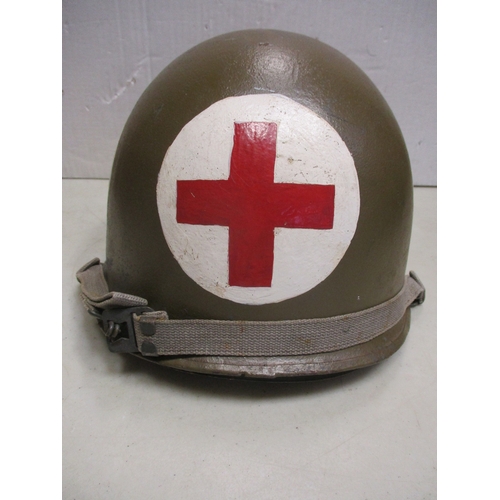 193 - WW2 U.S. Medic's M-1 helmet and liner, shell with khaki paint with large Red Cross on white circles ... 