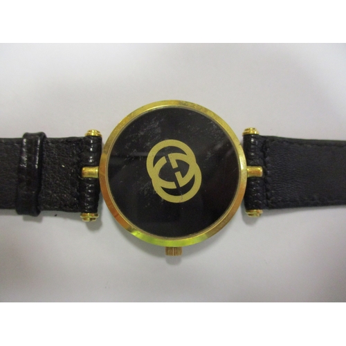 423 - Gucci unisex wrist watch, 30mm dial, gold coloured case, black dial with no numerals, Gucci, logo an... 