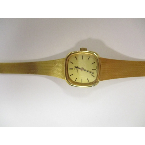 424 - Omega. Bracelet watch, 18ct gold, 'SWISS MADE' with plan dial, baton hands, stick indices, plain bez... 