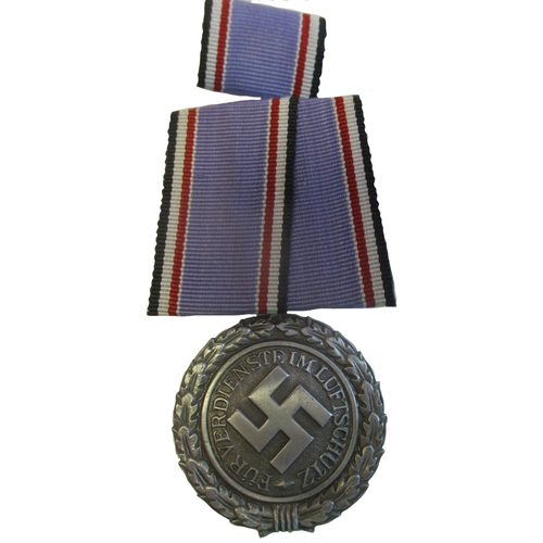 75 - Third Reich. Fire Service medals with:
1. Fire Brigade Honour Cross 2nd Class, some of silvering is ... 