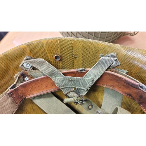 185 - U.S. Paratrooper's M-1 helmet and liner, green textured painted shell, webbing A strap with webbing ... 