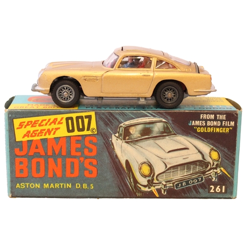 233 - Corgi. James Bond's Aston Martin DB5 No. 261, gold body, red interior, wire wheels, with James Bond,... 