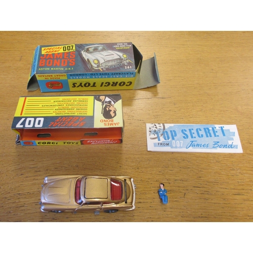 233 - Corgi. James Bond's Aston Martin DB5 No. 261, gold body, red interior, wire wheels, with James Bond,... 