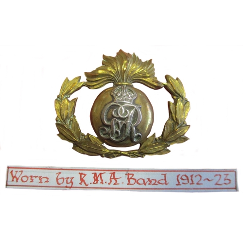 130 - Royal Marine Bands Portsmouth Division helmet plate and cap badge collection mounted on board includ... 