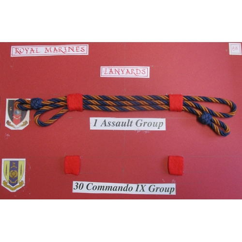 151 - Royal Marine collection mounted on 5 boards and 1 glass frame including embroided cap badges with Lo... 