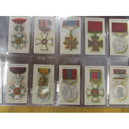 64 - Taddy. Complete set in plastic sleeves with 1915 Honours & Ribbons generally very good. Cat. £700. (... 