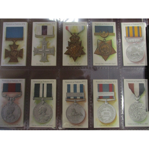 64 - Taddy. Complete set in plastic sleeves with 1915 Honours & Ribbons generally very good. Cat. £700. (... 