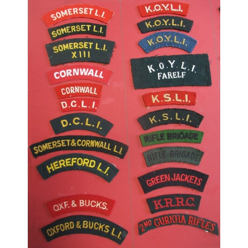 184 - Cloth shoulder title collection mounted on 2 boards with double sided tape. Mainly embroidered lette... 