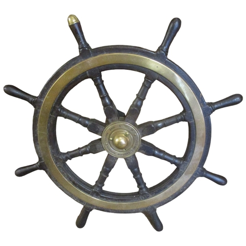 207 - A brass bound mahogany ships wheel, with eight turned spokes, one with brass acorn cap indicating th... 