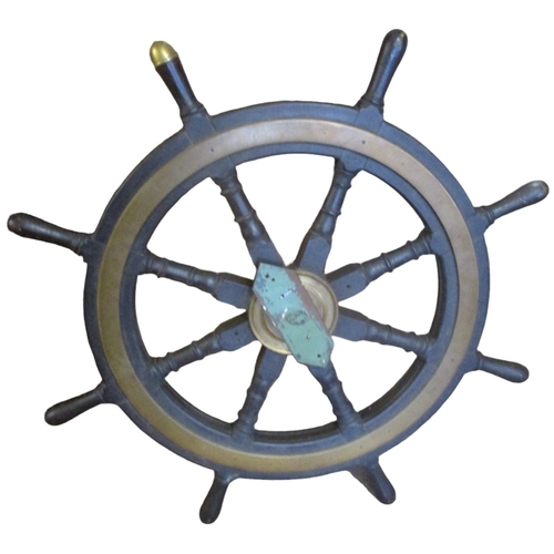 207 - A brass bound mahogany ships wheel, with eight turned spokes, one with brass acorn cap indicating th... 