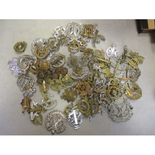 169 - Mixed accumulation in large box with good range of cap badges (60+), a few medals including copies, ... 