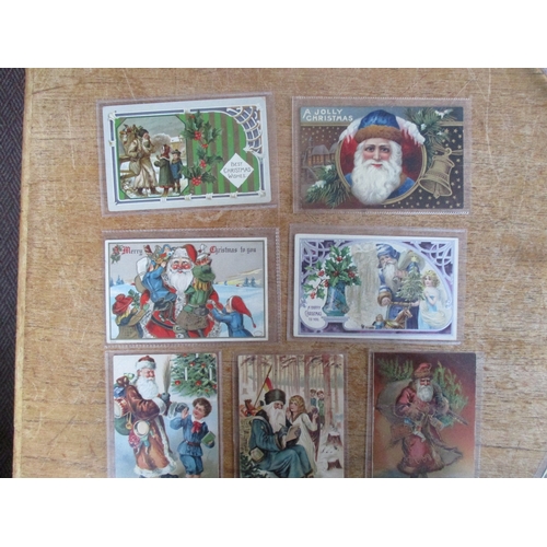 130 - Greetings. A coln. of Father Christmas cards with red robes, green, blue, brown and white (see photo... 