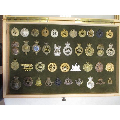 75 - Cap badge collection of mostly Infantry regiments and Royal Engineers including QV mounted on foam i... 