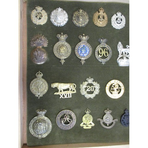 75 - Cap badge collection of mostly Infantry regiments and Royal Engineers including QV mounted on foam i... 