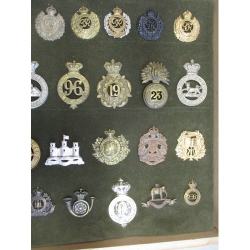 75 - Cap badge collection of mostly Infantry regiments and Royal Engineers including QV mounted on foam i... 