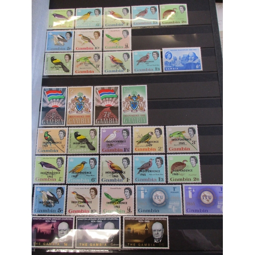 128 - Gambia. QEII UM ranges to approx late-1990s in 2 stockbooks. Many complete commems and defins sets i... 