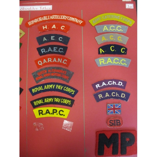 71 - Cloth shoulder title collection mounted on 5 boards with double sided tape, in a carrying case. Main... 