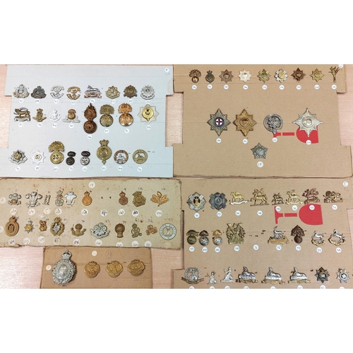 68A - Collection of cap badges consist of rifle/artillery regiments plus cloth shoulder titles and belt wi... 