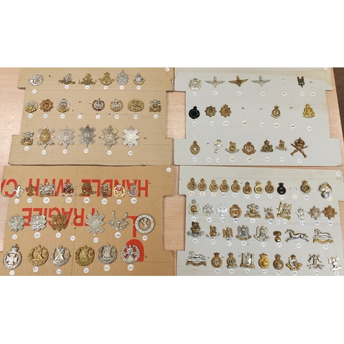 68A - Collection of cap badges consist of rifle/artillery regiments plus cloth shoulder titles and belt wi... 