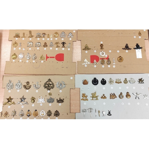 68A - Collection of cap badges consist of rifle/artillery regiments plus cloth shoulder titles and belt wi... 