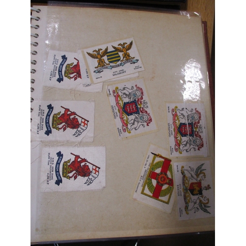 19 - Collection in albums and sleeves with Phillips silks including City Arms, Heraldic Series, Regimenta... 