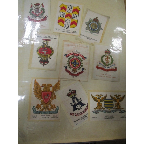 19 - Collection in albums and sleeves with Phillips silks including City Arms, Heraldic Series, Regimenta... 