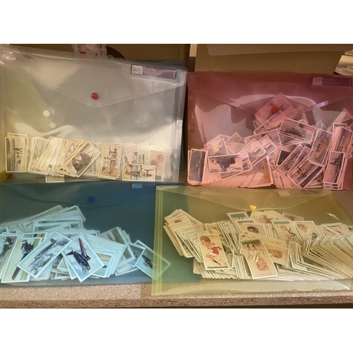 134 - Accumulation of cigarette cards and postcards, loose, in albums and paper albums, generally fair to ... 