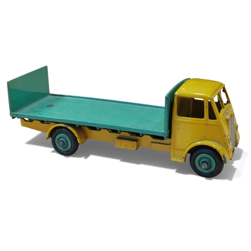 Dinky. Guy Flat Truck with Tailboard, yellow cab and chassis, mid green back and hubs, near very good in good plus box. (T)