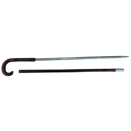 66 - Somali stick sword, dark red leather, crook style handle, about good very fine. BUYER MUST COLLECT.