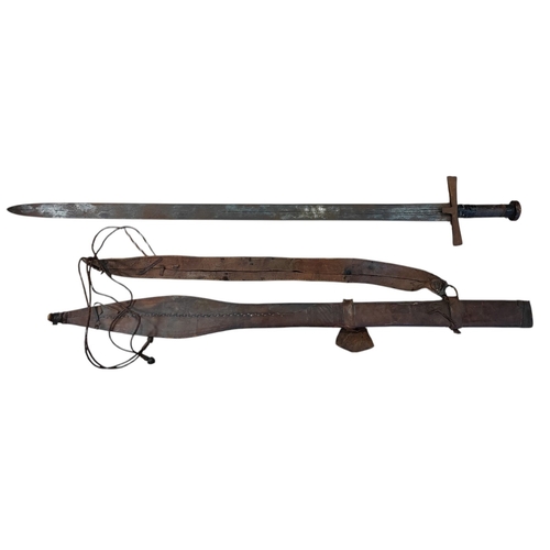 71 - Dominican Republic Kaskara sword with leather scabbard, 80% ornately etched blade with patterns and ... 