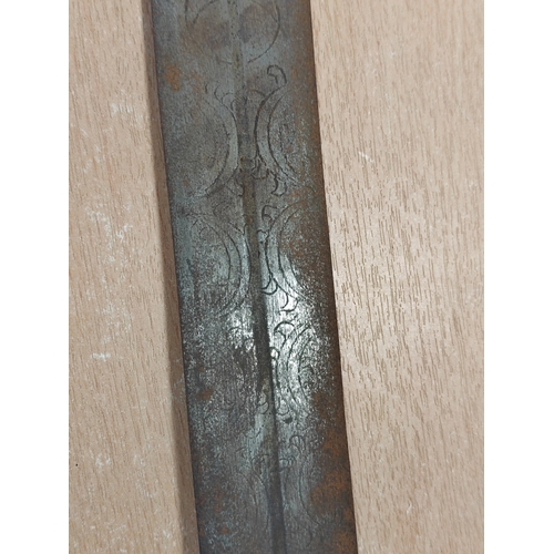 71 - Dominican Republic Kaskara sword with leather scabbard, 80% ornately etched blade with patterns and ... 