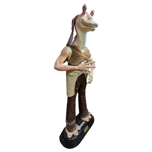 Star Wars. Gentle Giant. Life size statue of Jar Jar Binks from the film Star Wars: Episode I The Phantom Menace (approx. height 208cm), display model used to promote the film and Pepsi collectors cups, largely near excellent to excellent condition. Consists of Styrofoam body with interior armature (possibly repaired arm connectors). Arms, feet and bust covered with latex skin, in leatherette clothing, standing on a moulded plastic base with Star Wars logo and Jar Jar name plate. Head and arms can be removed. BUYER MUST COLLECT (Statue)