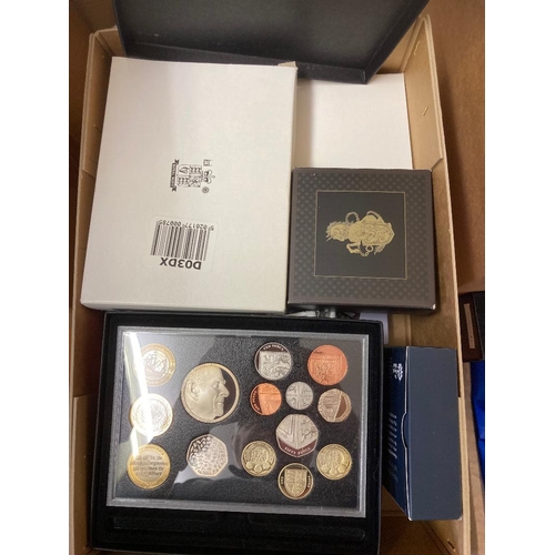 81 - COINS : Mixed box of UK Coin sets including £5 coins some enameled Poppy coins, plus silver proofs, ... 