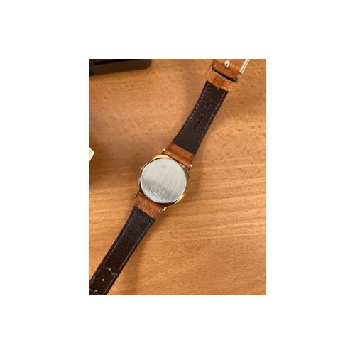 87 - WATCHES : Ladies Accurist wrist watch with light brown strap gold coloured case and white dial. prob... 