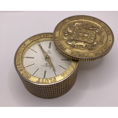 216 - Unusual travel clock with swivel lid in gilt metal with crest to top, UTI Swiza 7 jewells, alarm sou... 