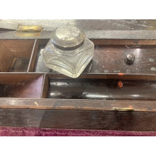 4 - Wooden writing slope probably Walnut with inlaid mother of pearl to lid, minor damage but it does in... 