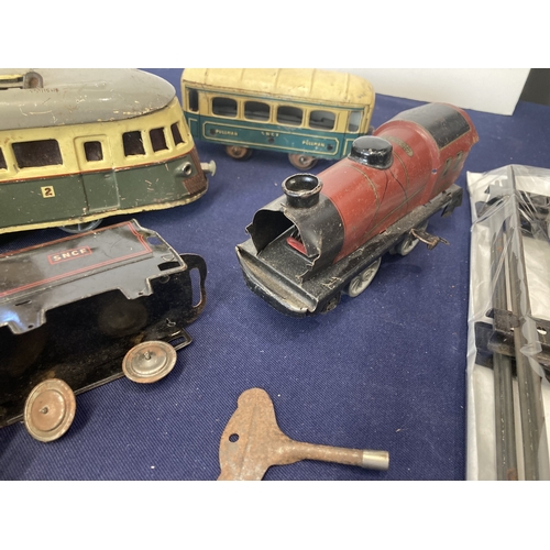 52 - French clockwork trains, three locos, one of which is a tram, made by Joustra (1930's), two other co... 