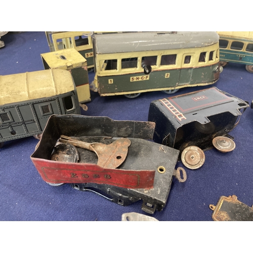 52 - French clockwork trains, three locos, one of which is a tram, made by Joustra (1930's), two other co... 