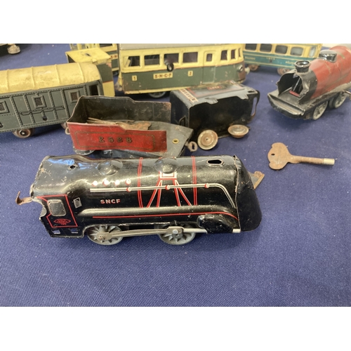 52 - French clockwork trains, three locos, one of which is a tram, made by Joustra (1930's), two other co... 