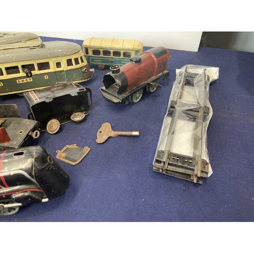 52 - French clockwork trains, three locos, one of which is a tram, made by Joustra (1930's), two other co... 