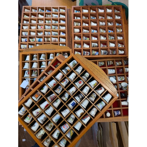 56A - THIMBLES, large collection of china thimbles, various designs in 15 display cases, (BUYER COLLECT) o... 