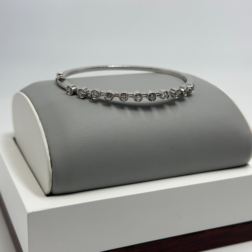 5 - An 18ct white gold diamond bangle, approx 1.10ct in total each stone approx 0.10ct, 7 1/2 inch wide,... 
