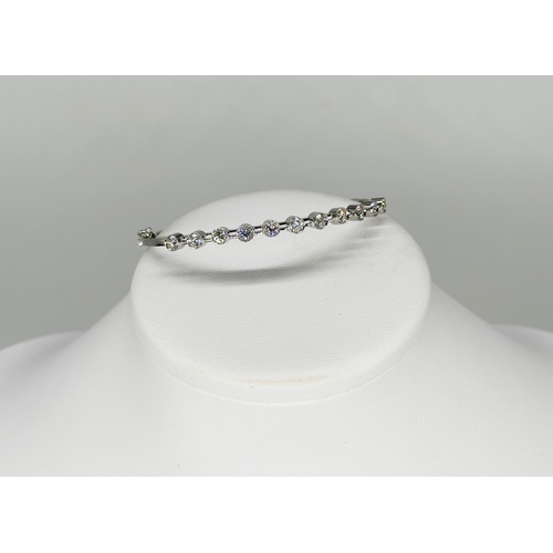 5 - An 18ct white gold diamond bangle, approx 1.10ct in total each stone approx 0.10ct, 7 1/2 inch wide,... 