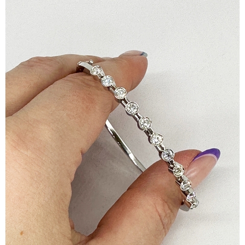 5 - An 18ct white gold diamond bangle, approx 1.10ct in total each stone approx 0.10ct, 7 1/2 inch wide,... 