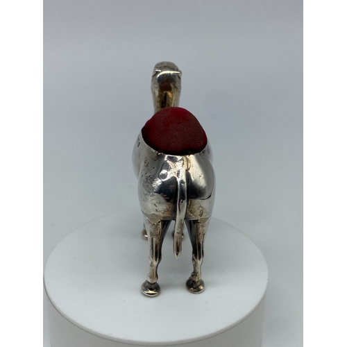 107 - A large silver camel pin cushion, Birmingham 1905 Adie & Lovekin ltd, in good condition, original fa... 