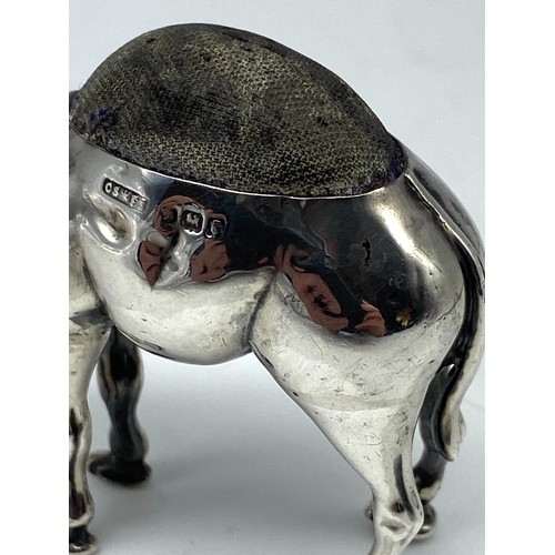 116 - A large silver camel pin cushion, Birmingham 1906 by Saunders & Shepherd, very good condition, 2 sma... 