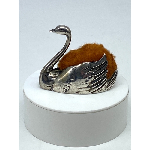 118 - A swan pin cushion, marked 800 continental silver, has a new replacement cushion, silver has some ru... 