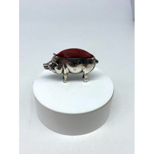 125 - A small silver pig pin cushion, Birmingham 1906 Adie & Lovekin ltd, overall good condition with orig... 