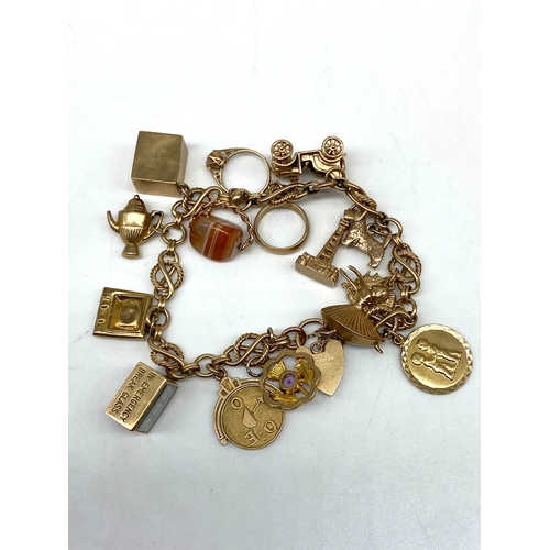 20 - A 9ct yellow gold charm bracelet, 14 charms, all fully hallmarked, 47.2 grams total approx weight,