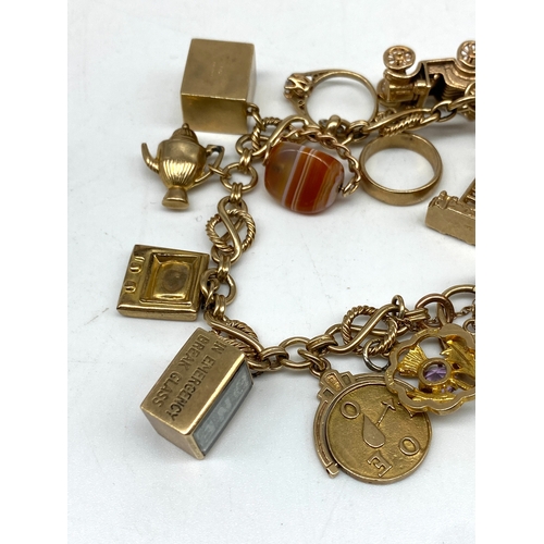 20 - A 9ct yellow gold charm bracelet, 14 charms, all fully hallmarked, 47.2 grams total approx weight,